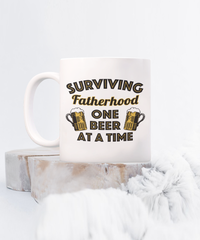 Load image into Gallery viewer, Surviving Fatherhood Funny White Coffee Mug, Father&#39;s Day, Birthday Gifts
